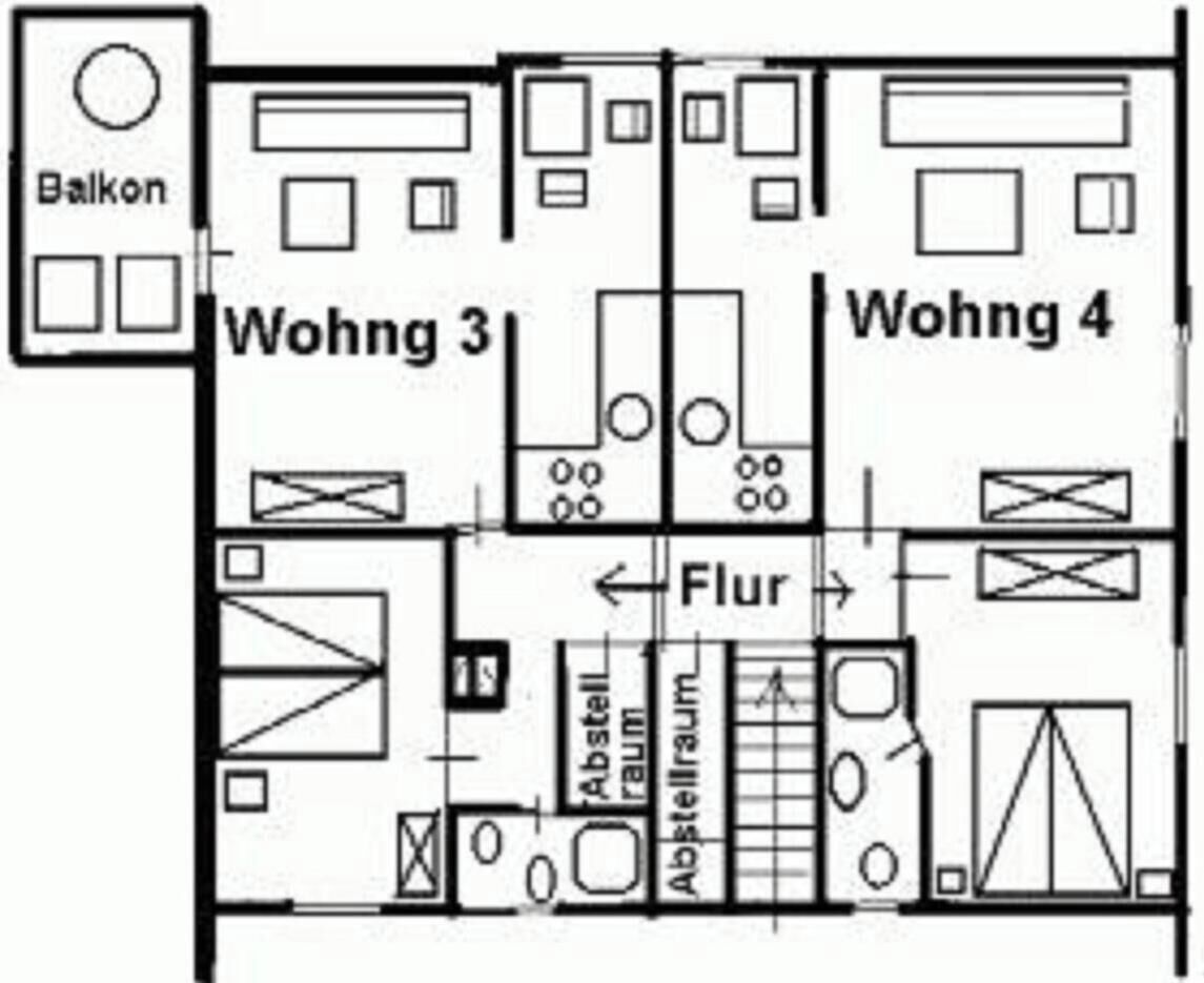 A floor plan with two living rooms, a balcony, and a stairwell.