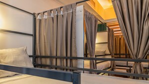 A bunk bed room with curtains, a bed, and a headboard. - TURQUOISE HOSTEL (Bucharest)