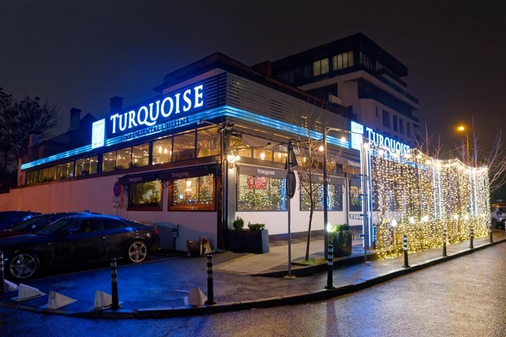 Un edificio con un letrero que dice 'Turquoise' y un escaparate bien iluminado.