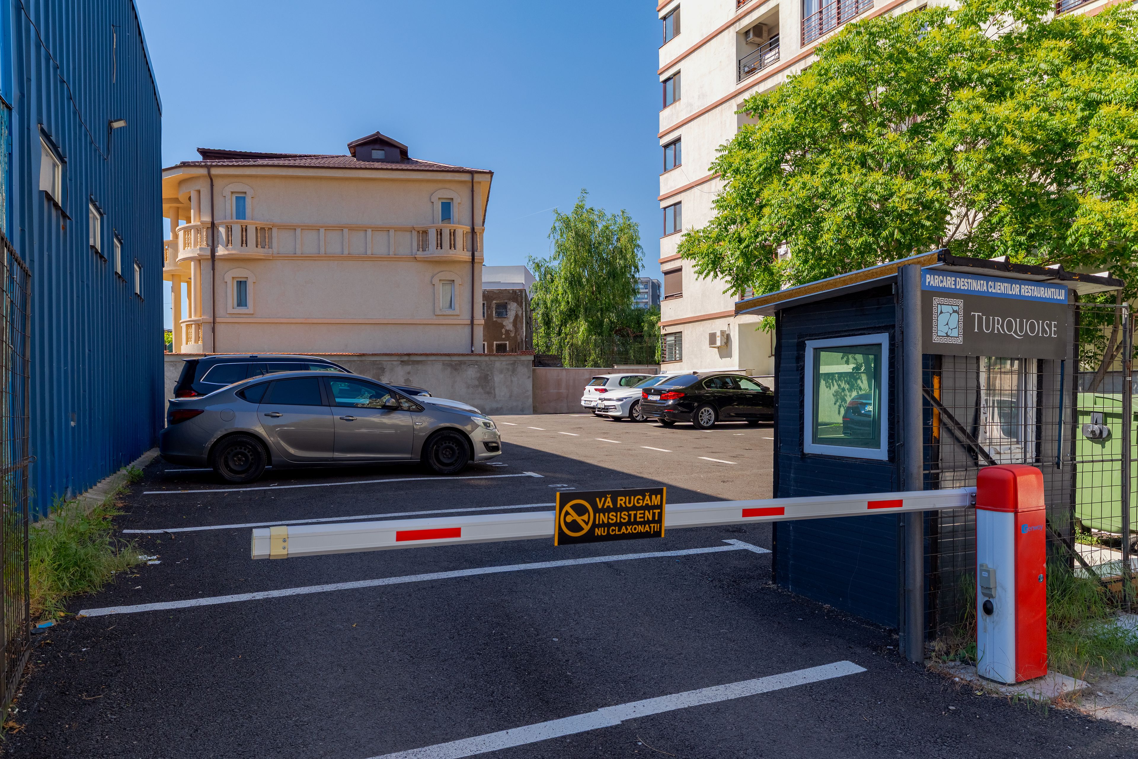 A gated parking area with a sign indicating no parking.