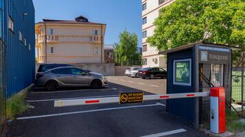 A gated parking area with a sign indicating no parking.