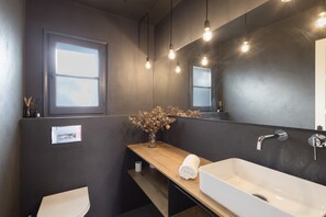 A modern bathroom with a white sink, a wooden vanity, a mirror, and a window. - House Next to Golf Course, 800 m from Platja de Pals (Pals)