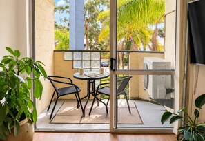 Interior - Stylish two-bedroom, resort-style apartment for up to four guests, five minutes from Fremantle city centre. Unwind with a king bed, two private balconies, shared pool, fast Wi-Fi, split-system air-conditioning and heating, and free undercover parking (Fremantle)
