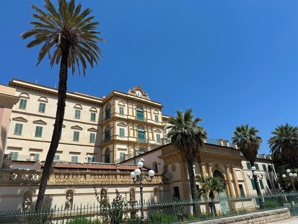 A historic building with classical architecture, including columns and arched windows.