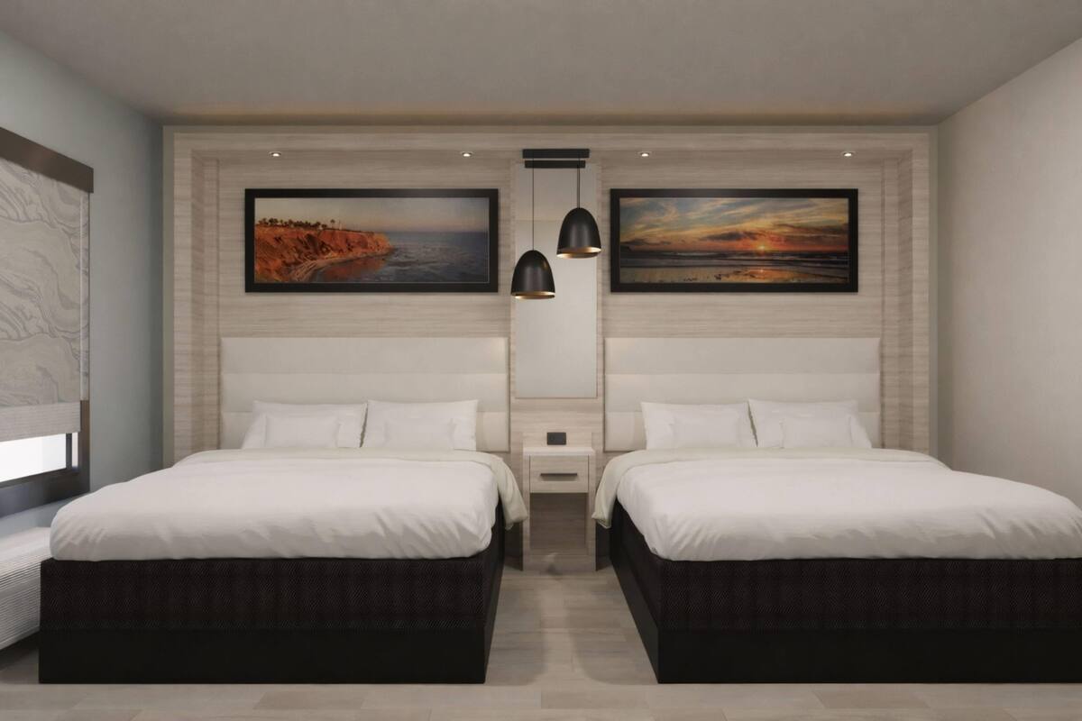 A modern hotel room with two beds, a nightstand, a wall-mounted shelf, and two paintings.
