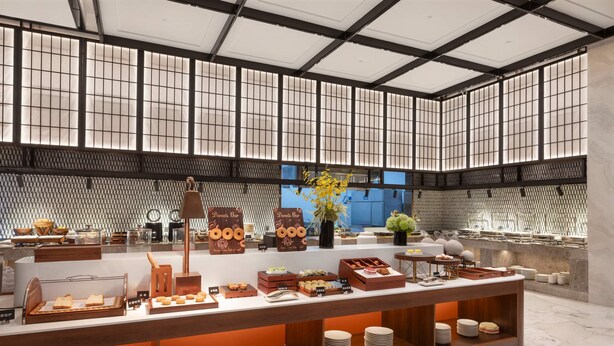A buffet setup with various food items and a coffee station. - Ramada by Wyndham Luzhou Longmatan (Luzhou)