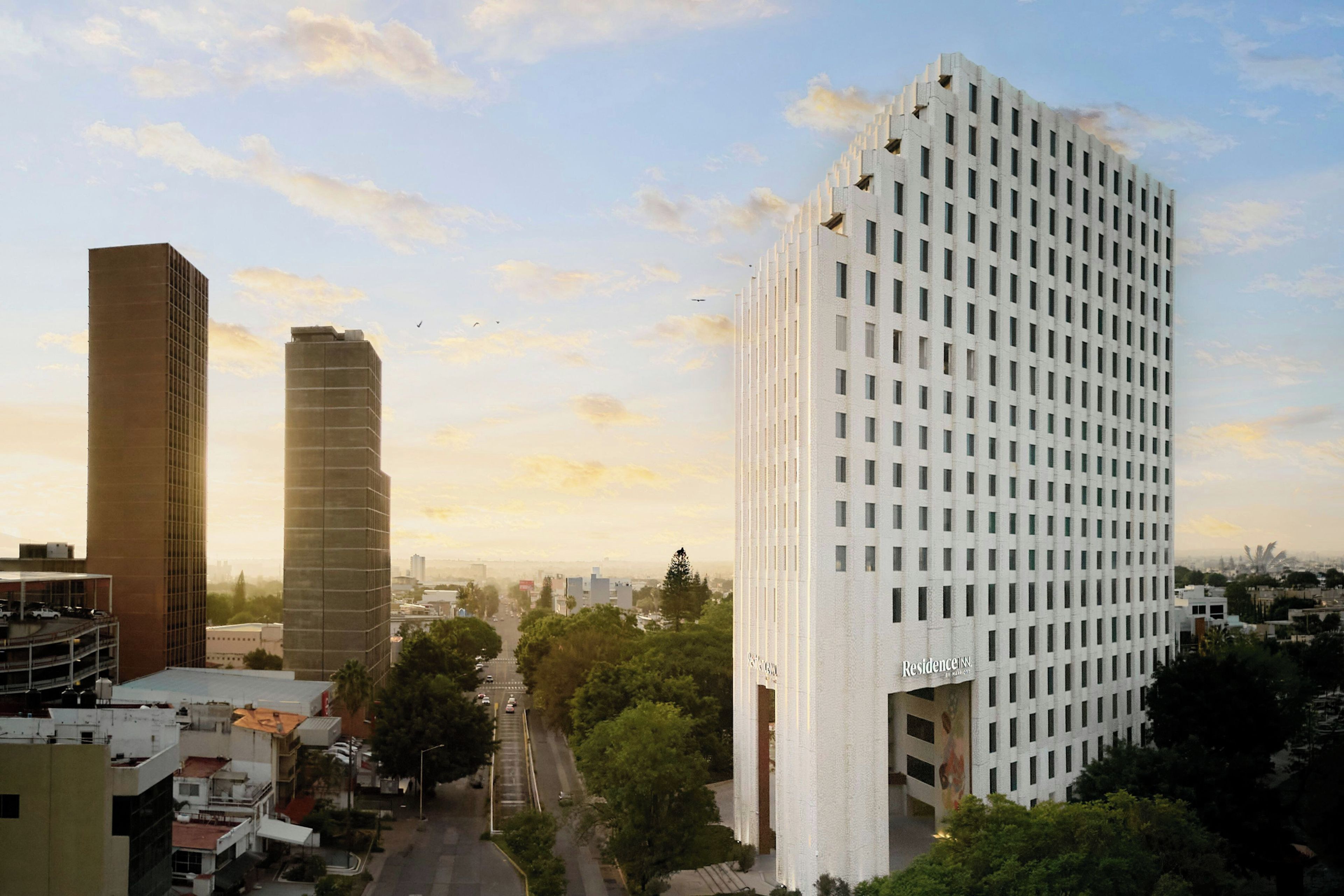 A high-rise building with a grid-like facade and a prominent 'Residence Inn' sign.