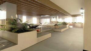 A modern indoor lounge area with seating, planters, and a slatted ceiling design. - Residence Inn by Marriott Guadalajara Country Club (Guadalajara)