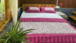 A bedroom with a bed, wooden walls, a window, a bedside table, and a potted plant. - Ganganiwas Homestay Sonada (Darjeeling)