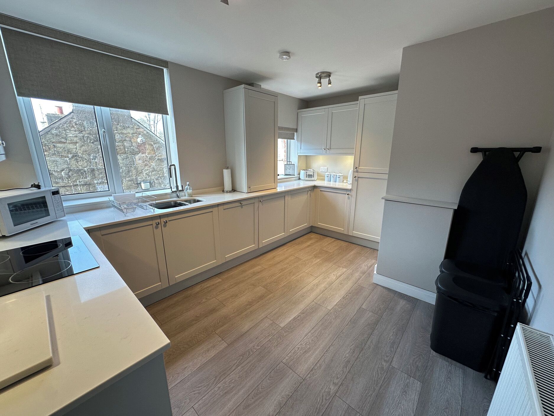 A modern kitchen with a microwave, toaster, and sink.