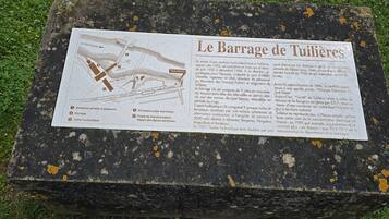 Een historische plaquette met een kaart en tekst over de Tuileries-dam, inclusief de constructie en het doel.