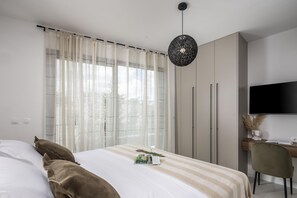 A bedroom with a bed, a desk, a chair, a television, and a wardrobe. - Villa Medellin Zadarvillas (Novigrad)