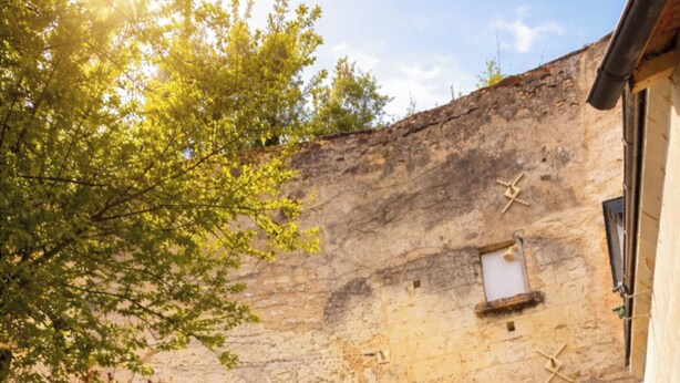 A stone building with a large window and a door, surrounded by trees and a gravel path. - Family home for a quiet stay close to all amenities! (Montrichard Val de Cher)