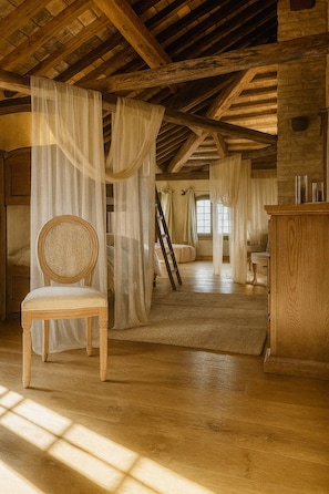 A rustic room with a wooden ceiling, a chair, a desk, and a ladder. - CA SALVA TEOLO:Charming country house nestled in the pleasant Veneto countryside (Veneto)