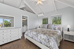 A bedroom with a large bed, a dresser, a vanity, and a ceiling fan. - 🌴Panoramic Ocean Views • Private Pool + Spa • AC • 4BR Kona Retreat Sleeps 10🌴 (Kailua Kona)