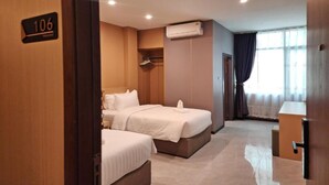 A hotel room with two beds, a wardrobe, an air conditioning unit, and a window with curtains. - Room-velin Pattaya Hotel-family 1 (Pattaya)