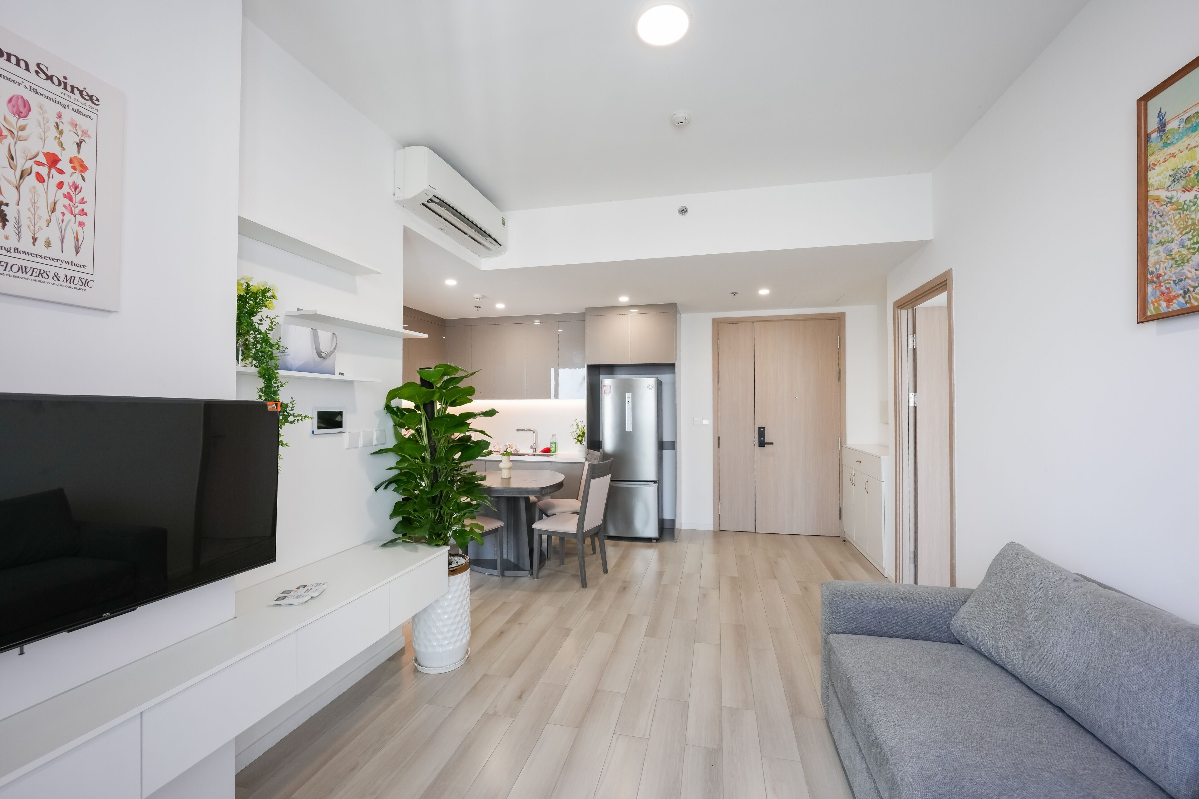 A modern apartment with a living area, kitchen, and dining space.