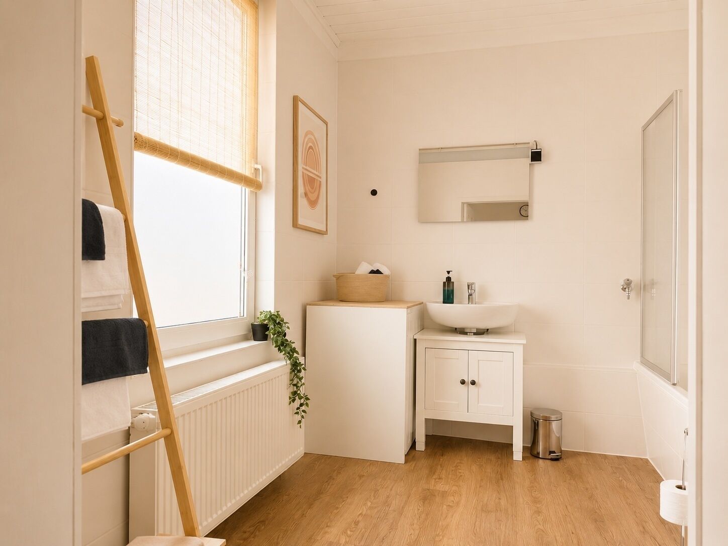 A bathroom with a wooden ladder, a white sink, a mirror, and a potted plant.