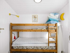 A bunk bed with a wooden frame, a red lamp, a framed picture on the wall, and a banana-shaped decoration. - 4 Star Holiday Home in Lokken (Lokken)