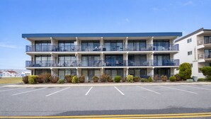 A multi-story hotel with a parking lot in front. - Eldorado 2 - Ocean City, MD (Ocean City)