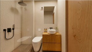 Un baño moderno con ducha, inodoro y tocador.