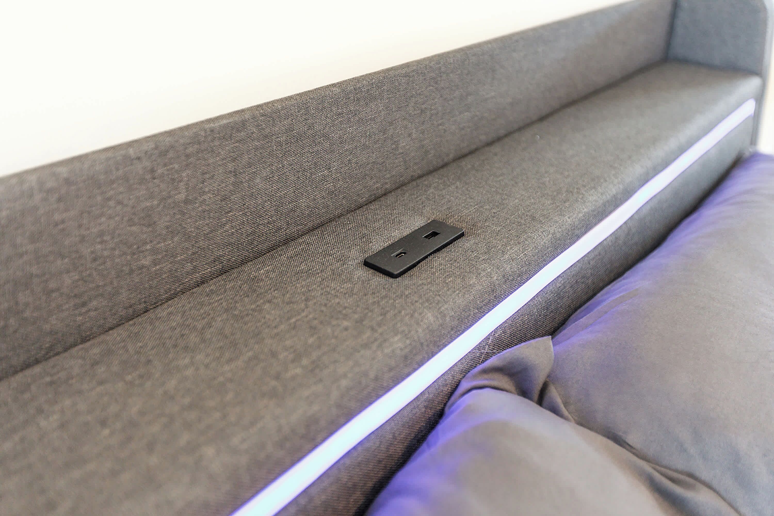 A sofa with a built-in power outlet.