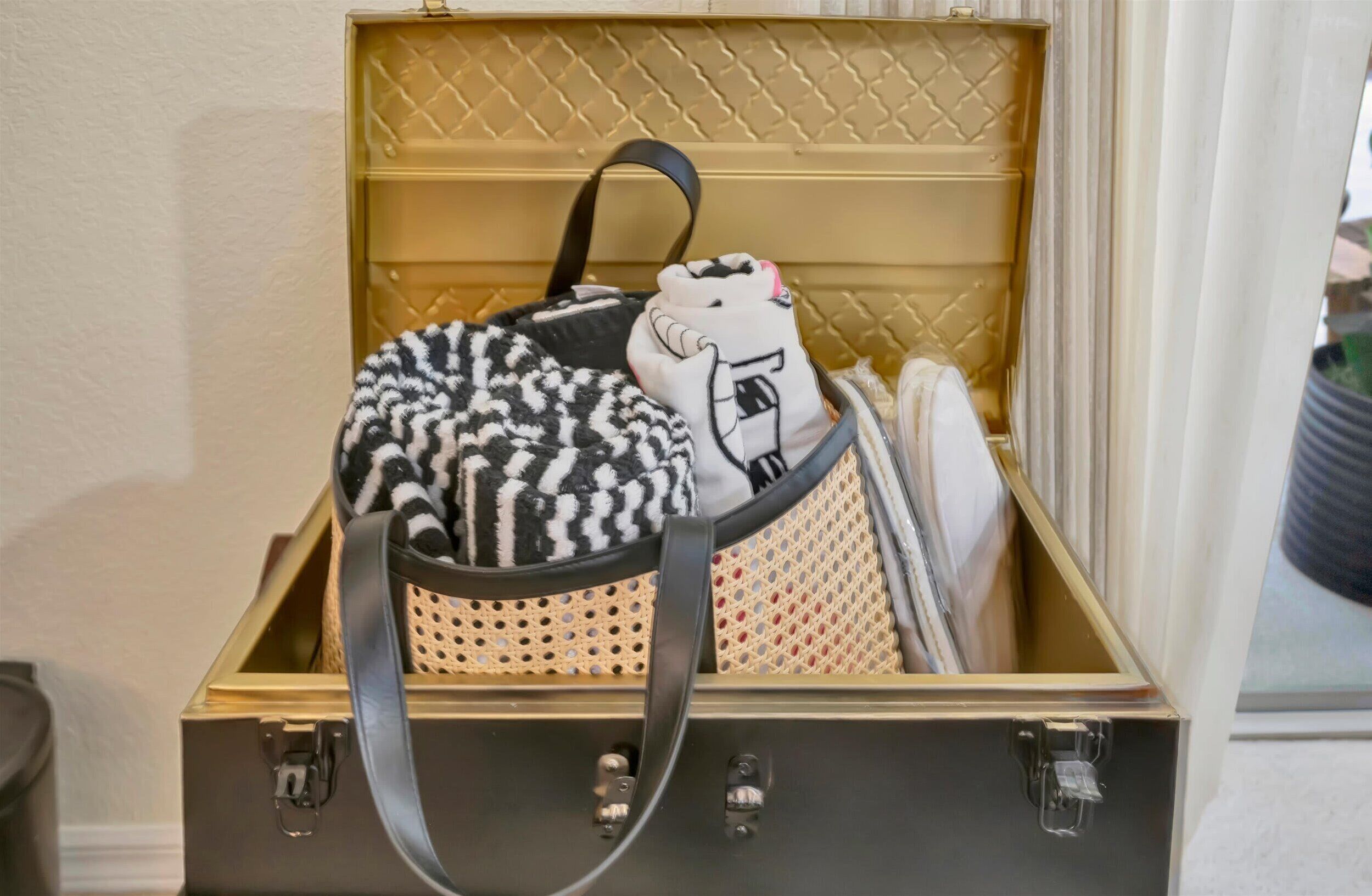 A suitcase with a quilted interior and a handle.