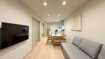 Comfort Apartment | Living area | 55-inch Smart TV with cable channels
