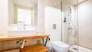 A bathroom with a sink, mirror, toilet, and glass shower enclosure. - Panellinion Beachfront Getaway - Sea Sunny Gem (Kalamata)