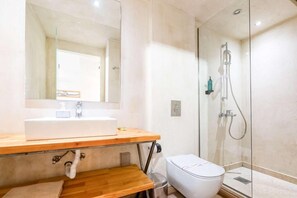 A bathroom with a sink, mirror, toilet, and glass shower enclosure. - Panellinion Beachfront Getaway - Sea Sunny Gem (Kalamata)