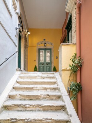 A set of stone steps leading to a green door with a number 22 sign above it. - Alexandras Luxury Heaven (Corfu)