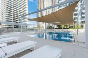An indoor swimming pool with white lounge chairs and a large canopy. - Free Housekeeping Visits During Your Stay - Stayshort - Relaxing 1 Bed That Sleeps 4 With Amazing Views From Balcony (Dubai)