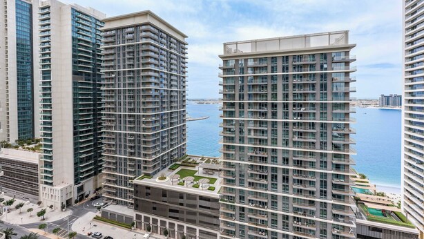 A high-rise building with multiple floors, large windows, and a view of the sea. - Free Housekeeping Visits During Your Stay - Stayshort - Relaxing 1 Bed That Sleeps 4 With Amazing Views From Balcony (Dubai)