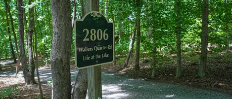 A sign with the number 2806 and the text 'Waller's Quarter Rd Life at the Lake'.