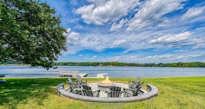 Lakefront retreat with a large yard, stone fire pit, gazebo, deck, & dock