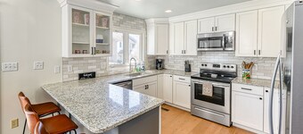 Three-story lakefront home w/ covered boat slip, and tennis/pickleball access