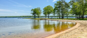 Three-story lakefront home w/ covered boat slip, and tennis/pickleball access