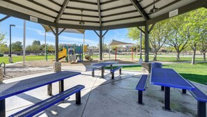 A covered picnic area with benches and a playground in the background. - On Johnson Ranch Golf Course: San Tan Valley Home (San Tan Valley)