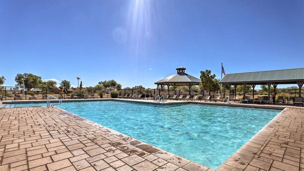 A swimming pool with a gazebo and lounge chairs. - On Johnson Ranch Golf Course: San Tan Valley Home (San Tan Valley)