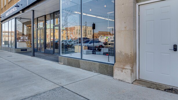 A storefront with large glass windows, a sign reading 'The Loft Room by Samson Historical,' and a white garage door to the right. - Historic Lebanon Gem: Central Walkable Location! (Lebanon)