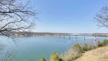 A bridge over a calm lake with clear skies.
