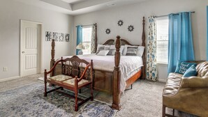 A bedroom with a four-poster bed, a wooden chair, a sofa, and a chandelier. - 8 Mi to Dtwn & Film Sites! Spacious Covington Home (Covington)