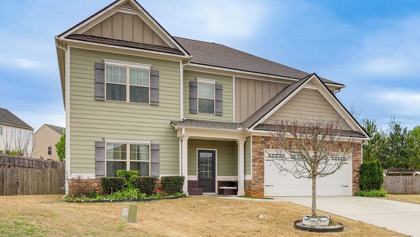 A two-story house with a front porch, a garage, and a small tree in the front yard. - 8 Mi to Dtwn & Film Sites! Spacious Covington Home (Covington)