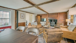 A room with a wooden ceiling, a fireplace, a television, and a dining area with chairs and a table. - 4 Mi to Noannet Pond: Pet-friendly Home w/ Yard (Dover)