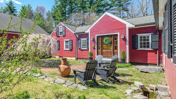 A red house with a front door, two windows, and a porch with chairs. - 4 Mi to Noannet Pond: Pet-friendly Home w/ Yard (Dover)