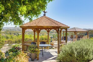 A wooden gazebo with a tiled roof, surrounded by potted plants and outdoor furniture. - Outdoor Oasis w/ Valley Views: Temecula Escape (Temecula)