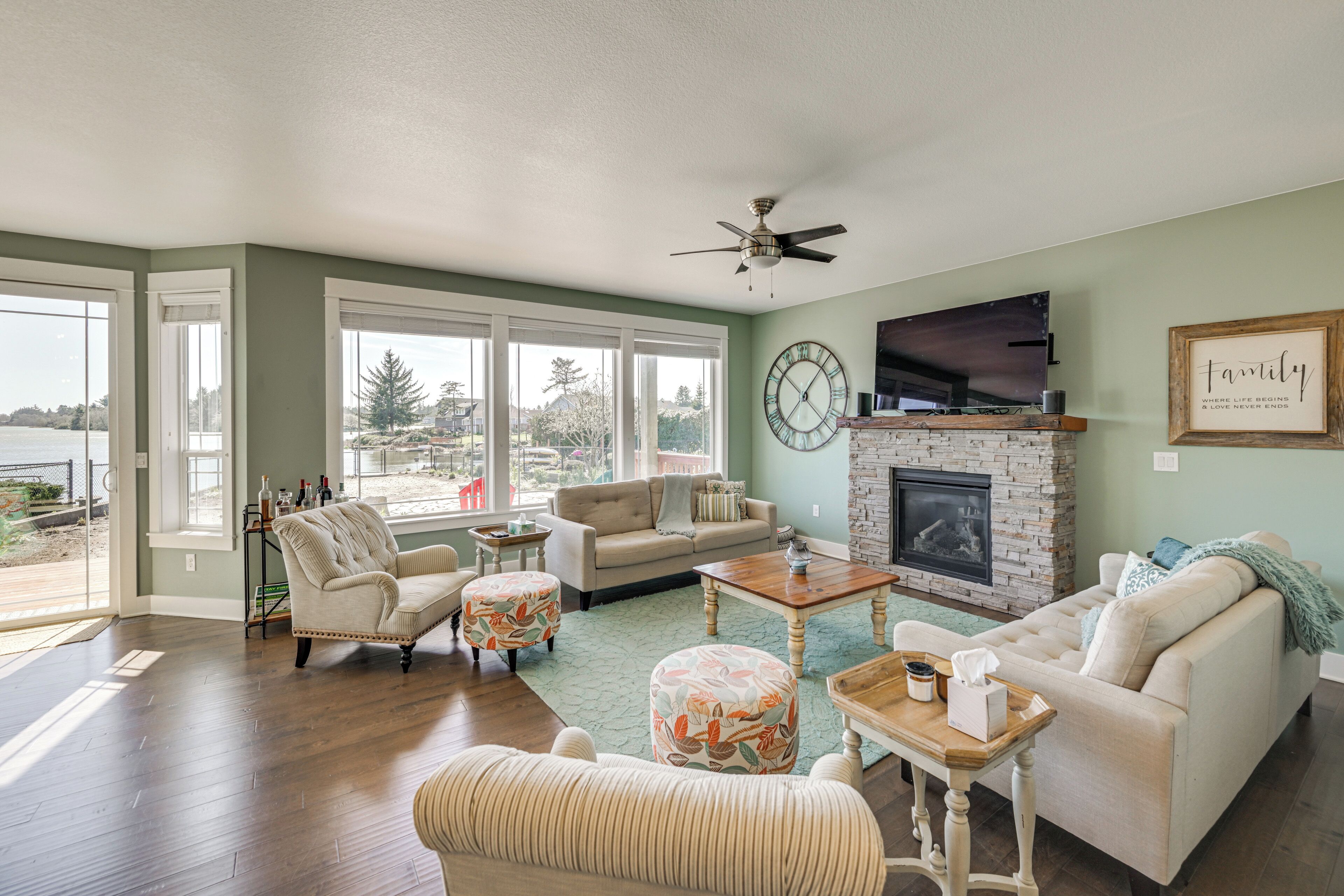 A living room with a fireplace, a sofa, a coffee table, and a television.