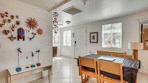 A dining area with a table, chairs, a bench, and wall decorations. - Shop & Dine! Getaway 3 Mi to Old Town Scottsdale (Scottsdale)