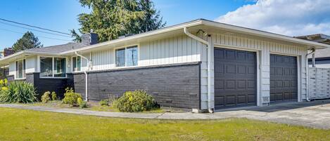 A single-story house with a garage, a covered porch, and a well-maintained lawn.