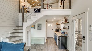 A multi-level home with a staircase, a kitchen, and a dining area. - Nature Stay By Guntersville Lake! Cozy Guest Cabin (Grant)